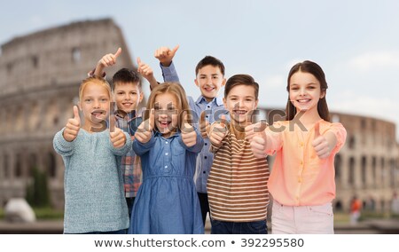 Stock photo: Friends Showing Thumbs Up Over Coliseum Background