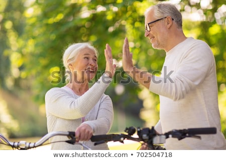 Stock photo: Couple With Bicycles Making High Five In Summer