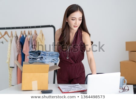 Stock photo: Business Woman Working On Her Laptop With Online Storage And Cloud Technology Concept