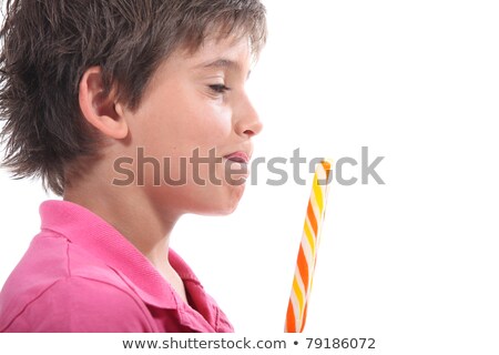 Stockfoto: Young Boy Licking His Lips At The Sight Of His Lollypop