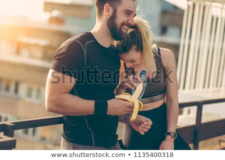 Foto stock: Young Man And Two Attractive Women With Bananas