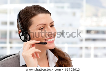 Stock photo: Female Operator On The Phone With Earpiece Sitting In Her Office