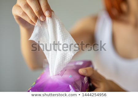 Stok fotoğraf: Wet Wipes Women Take One Wipe From Package For Cleaning