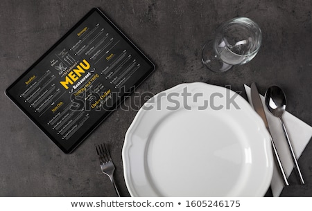 ストックフォト: Tableware With Online Menu On Tablet