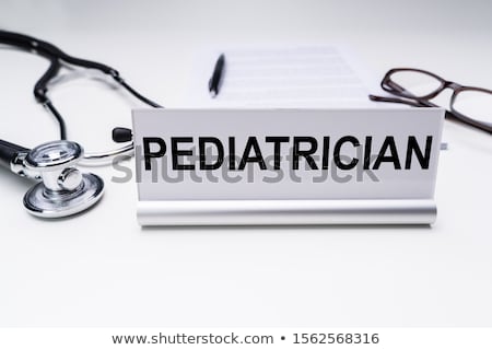 Foto d'archivio: Pediatrician Job Title On Nameplate Over Desk