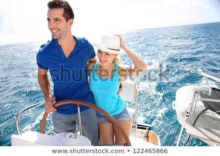 Сток-фото: Young Couple Steering A Catamaran