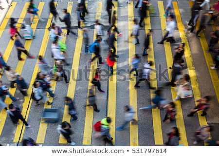 Foto stock: People Moving On Zebra Crosswalk At Crowded City Hong Kong