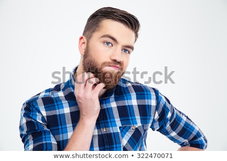 Foto stock: Portrait Of A Pensive Man Touching His Beard With Hand