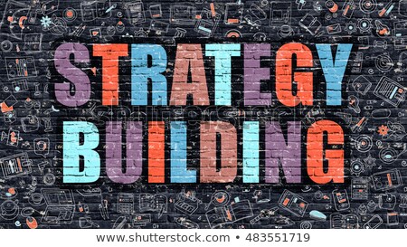 Stok fotoğraf: Strategy Building Concept Multicolor On Dark Brickwall