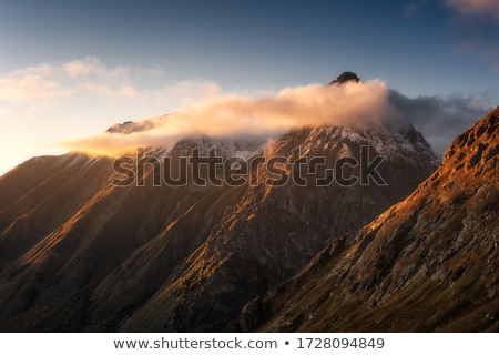 Сток-фото: Stone Pile With Mountain Peaks In Background