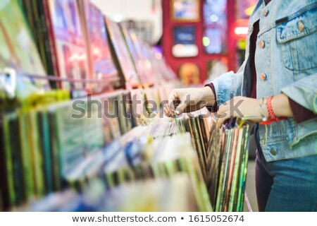 ストックフォト: Young Woman Choosing Vintage Vinyl Lp In Records Shop