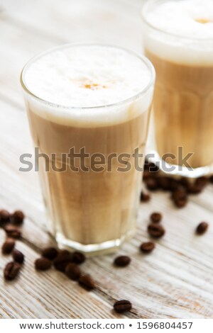 Two Glasses Latte Macchiato With Coffee Beans And Chocolate Powder Foto stock © almaje