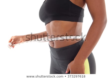 Stockfoto: Midsection Of Woman Measuring Waist