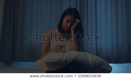 Stock photo: Depressed Teenage Girl Sitting In Bedroom With Pills