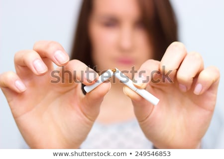 Stock photo: Close Up Young Woman Breaking A Cigarette Stick