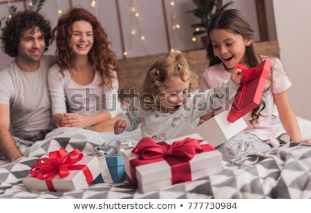 商業照片: Child Opening Christmas Present