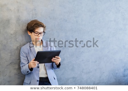 Stock photo: Teen Schooler Boy In Eyeglasses Holds Tablet Pc