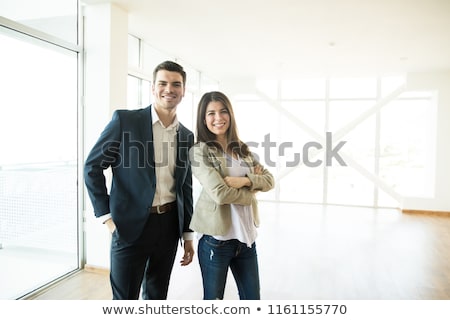 ストックフォト: Couple In Business Suits Standing Together With Arms Crossed