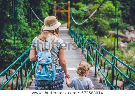 Foto stock: Mother And Son Are Going On A Suspension Bridge Traveling With Children Concept