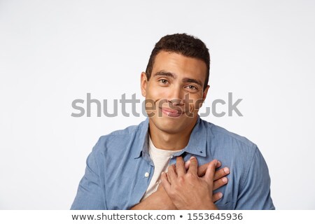 Zdjęcia stock: Close Up Pleased Flattered Young Hispanic Man Press Hands To Heart Smiling Touched And Delighted
