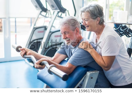 Stockfoto: Mature Man Doing Exercise For Biceps On Grey Background