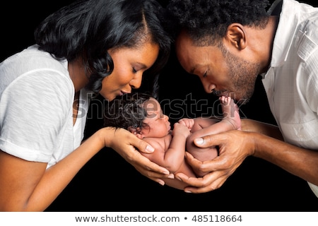 Zdjęcia stock: Hands Of Father And Mother Hold Newborn Baby On Black
