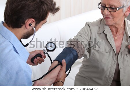 Stock foto: Man Taking The Pulse Of An Older Woman