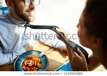 Foto stock: Woman Pulling Man For His Tie