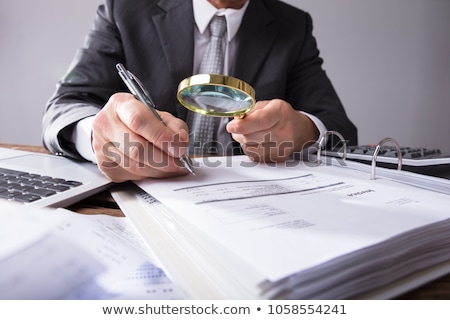 Zdjęcia stock: Auditor Looking Invoice Through Magnifying Glass