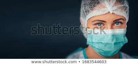 Foto stock: Young Female Medical Nurse Or Doctor Wearing Protective Mask