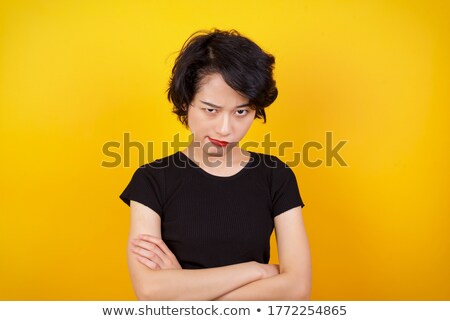 Stock photo: Portrait Of A Depressed Asian Woman Standing With Arms Folded