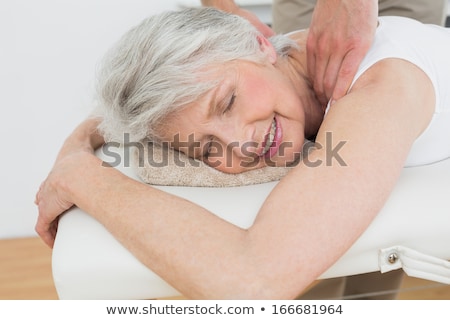 Stockfoto: Physiotherapist Massaging Senior Mans Shoulder