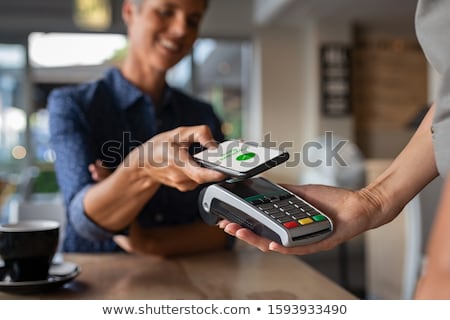 Foto stock: Hand Paying With Cellphone On Pos