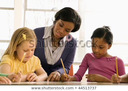 Teacher Helping Students With Schoolwork In School Classroom Ho Imagine de stoc © iofoto