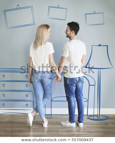 Stockfoto: Rear View Of A Young Couple Looking At Men Clothes Standing In A Shop