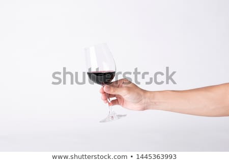 Foto stock: Mans Hand With Glass Of Red Wine Isolated On White