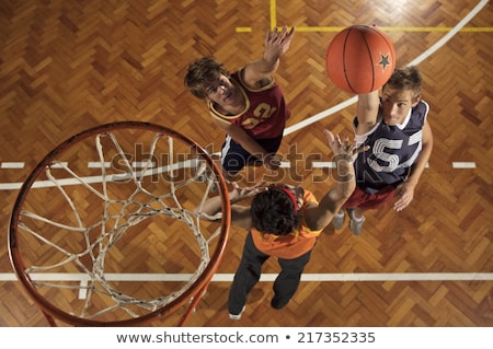 Foto d'archivio: Three People Playing Basketball