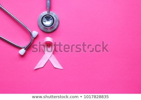 Foto d'archivio: Breast Cancer Awareness Pink Ribbon On A Stethoscope With A White Background