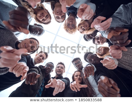 Foto d'archivio: Happy Friends Pointing At You Standing In Circle