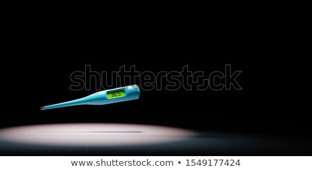 Stock foto: Clinical Digital Thermometer Spotlighted On Black Background