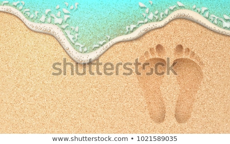 Foto stock: Human Footprints In The Sand At The Beach