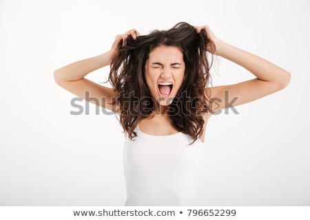 Stok fotoğraf: A Portrait Of A Young Frustrated Woman Pulling Out Hair Over Whi