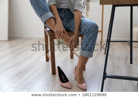 Stockfoto: Business Woman Taking Off Shoes