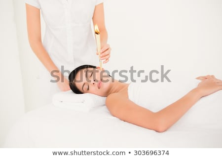 [[stock_photo]]: Beautiful Woman Receiving Ear Candle Treatment At Spa Center
