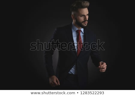 Stock photo: Portrait Of Curious Smart Casual Man Looking Down To Side