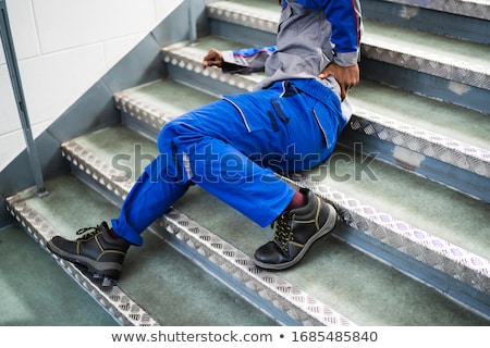 Stockfoto: Worker Man Lying On Staircase