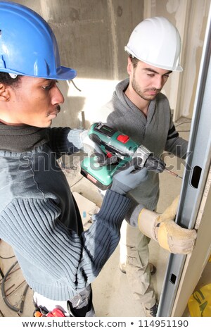 [[stock_photo]]: Tradesmen Installing Drywall
