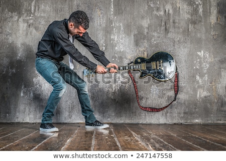 Foto d'archivio: Rocker Man Breaking A Guitar