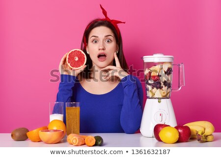 Stok fotoğraf: Closeup Of Young Female In Glasses Holding Bananas