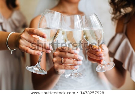 Foto stock: The Bride And Her Bridesmaid With A Glass Of Wine